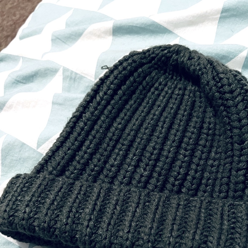 Knitted green beanie.